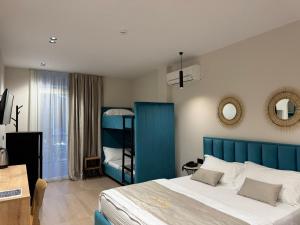 a bedroom with a blue bed and a bunk bed at Villa La Mer Durres in Durrës