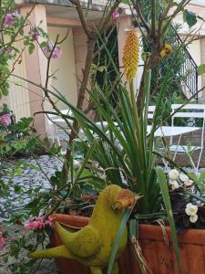a small green bird statue in a garden at Les Gites du Mont Ventoux in Bédoin
