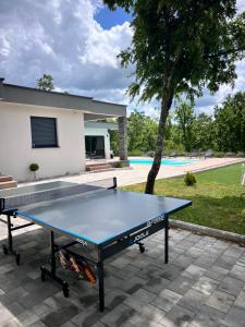 a ping pong table in front of a house at Luxury Villa Mojito in Široki Brijeg