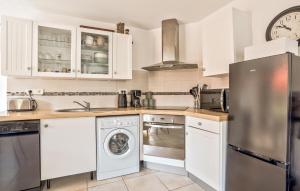 a kitchen with white cabinets and a dishwasher at Lovely Home In Quettreville-Sur-Sienne in Quettreville-sur-Sienne