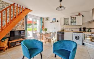 a kitchen with a table and chairs and a staircase at Lovely Home In Quettreville-Sur-Sienne in Quettreville-sur-Sienne