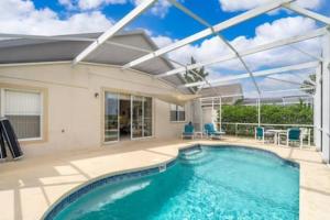 a swimming pool in a house with a glass roof at Unique comfortable Golf course Home w Private Pool in Davenport