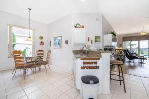 a kitchen and living room with a table and chairs at Unique comfortable Golf course Home w Private Pool in Davenport