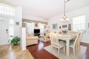 a dining room and living room with a table and chairs at Unique comfortable Golf course Home w Private Pool in Davenport
