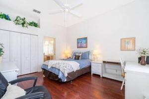 a bedroom with a bed and a desk in it at Unique comfortable Golf course Home w Private Pool in Davenport +26 photos