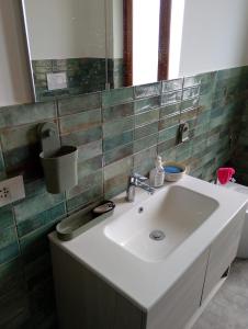 a bathroom with a white sink and a mirror at Casa Acerbi Quarto Priaruggia in Genoa +35 photos