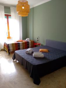 a bedroom with a bed with two towels on it at Casa Acerbi Quarto Priaruggia in Genoa