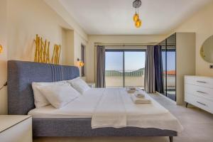 a bedroom with a large bed with a balcony at Çukurbağ Köyü Doğa Manzaralı Villa Oriente in Kas +35 photos