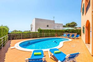a swimming pool with lounge chairs and a swimming pool at Villa Marcolis Mar in Cala Galdana
