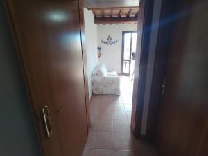 an open door to a hallway with a chair in a room at La casa di Arturo Pet friendly Apartments in Riparbella +13 photos