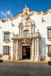 a large building with a clock on the front of it at Palacio Marques de la Gomera in Osuna