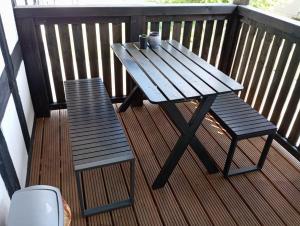 a picnic table and a bench on a balcony at Hauptstr 10- 04603 Remsa in Windischleuba