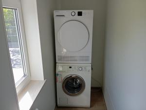 a washer and dryer in a room with a window at Hauptstr 10- 04603 Remsa in Windischleuba