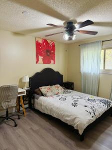 a bedroom with a bed and a ceiling fan at Gorgeous House&30 second Bus station Close C-Train& Free Parking in Calgary +13 photos