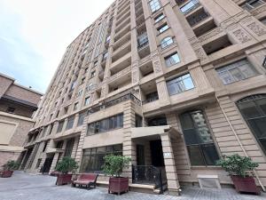 a large building with benches in front of it at Saphire apartment by Bakuapart in Baku