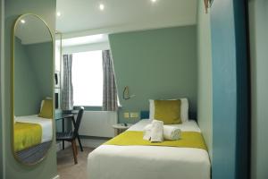 Postel nebo postele na pokoji v ubytování Bloomsbury Palace Hotel