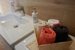 a box of towels sitting on a bathroom sink at Casa Selvaggio Blu in Santa Maria Navarrese +26 photos