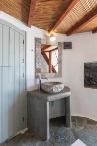 a bathroom with a sink in a room at WindMilos in Tripití +28 photos