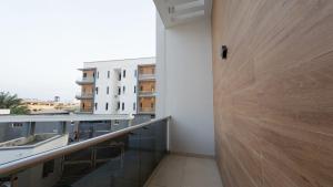 a hallway with a wooden door in a building at Brown condo in Lekki