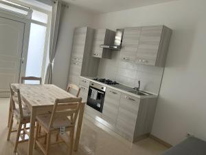 a kitchen with a table and a stove top oven at CasaPrati in Grammichele