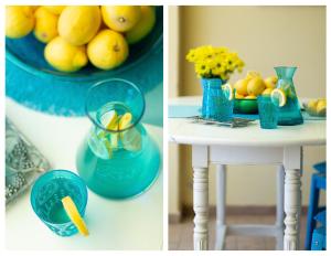 a table with blue vases and a bowl of lemons at Il Nido di Montiano, giardino, natura e relax in Magliano in Toscana +6 photos