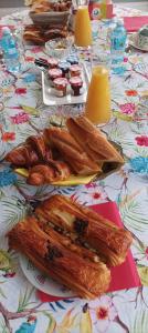 a table with a plate of bread and pastries on it at L'HIBISCUS de l'Audière in Malaunay