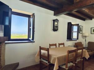 a dining room with a table and a window at El Tirao de Suesa - 34800 in Suesa
