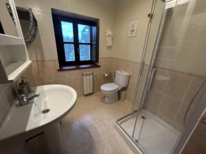 a bathroom with a toilet and a sink and a shower at El Tirao de Suesa - 34800 in Suesa +28 photos