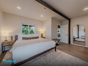 a bedroom with a large bed and a large mirror at Kanab Cube Shipping Cube Rental Experience in Kanab