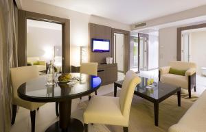 a living room with a dining table and a living room at Golf Royal Hotel in Tunis