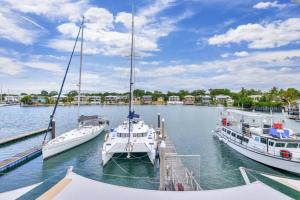three boats docked at a dock in the water at Marina View Sunset Magic in Larrakeyah