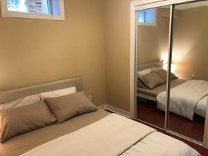 a bedroom with a mirror and a bed and a mirror at 2 Bed-2Bath-Kitchen Private Family Couple Work in Newmarket