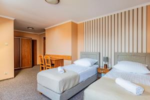 Postel nebo postele na pokoji v ubytování Zajazd Żuławy - Restauracja & Hotel