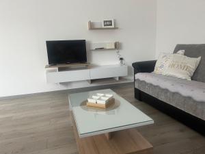 a living room with a couch and a coffee table at Apartmanii Gajić in Kuršumlija