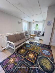 a living room with a couch and a rug at Qloud Cottage Kundasang in Ranau +35 photos
