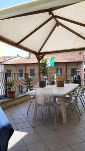 a table and chairs under an umbrella on a patio at Il Ragno D`Oro in Rho