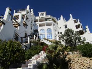 a large white building on top of a hill at Apartamento Calahonda in Mijas Costa