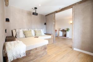 a bedroom with a bed and a large window at Maison Bello - La Suite Bohème in Beaupréau