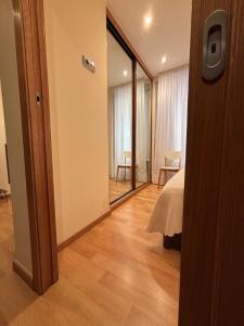Un dormitorio con una cama y un espejo grande. en Apartamento céntrico O Castelo, en Pobra do Caramiñal