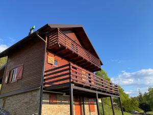 a building with a balcony on the side of it at Brvnara Jevtic, Tara in Mokra Gora
