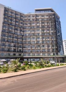 a large building with a road in front of it at LoxwoodStudio by UniqueView in Accra