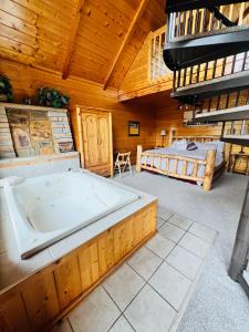 a large room with a bath tub and a bed at Daa Bears Lodge in Gatlinburg
