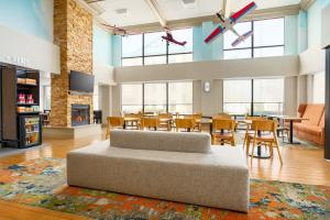 a large living room with a couch and tables and chairs at Hampton Inn Chicago-Midway Airport in Chicago