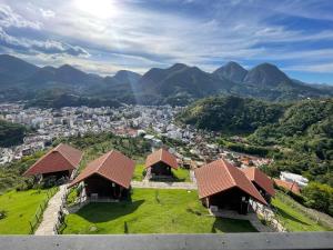 a view of a city with mountains in the background at LOFT Friburgo in Nova Friburgo +20 photos