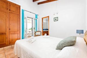 a bedroom with a white bed with towels on it at Villa Bini Anna by Villa Plus in Binibeca +20 photos