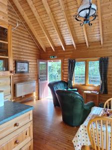 a living room with two leather chairs and a table at Springburncabins in Elgin