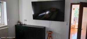 a flat screen tv on a wall in a room at Pension Kaden in Dresden