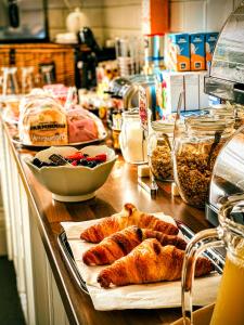a counter with pastries and other food items on at Gresham Court in Torquay