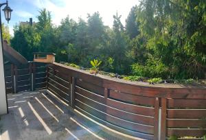 a wooden fence with a garden on top of it at Pension Kaden in Dresden +6 photos