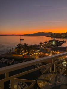 a view of the ocean at sunset from the balcony of a resort at Sun N Blue Hotel in Sarandë